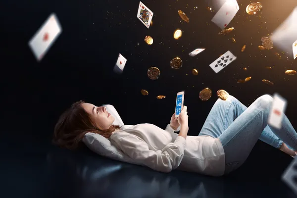 KKDB App — Enjoy seamless gaming on your smartphone A young woman relaxing with her phone while dynamic casino elements float around her, illustrating the smooth mobile experience offered by the KKDB app.