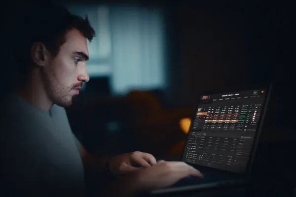 KKDB App — Fast, responsive, and optimized for all devices A cheerful woman in traditional clothing using her smartphone during a festive moment, showing how easily the KKDB app fits into everyday life.