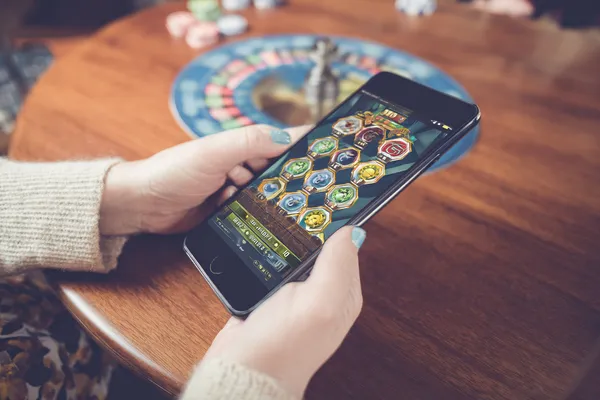 KKDB Mobile App — Your complete hub for casino and sports A man focused on his laptop with live stats in the background, highlighting the dedicated sports and gaming features of the KKDB mobile app.