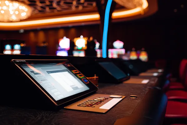 KKDB Games — Discover modern slots and table adventures A man celebrating a winning moment on his laptop while gaming symbols float around him, capturing the excitement of KKDB games.